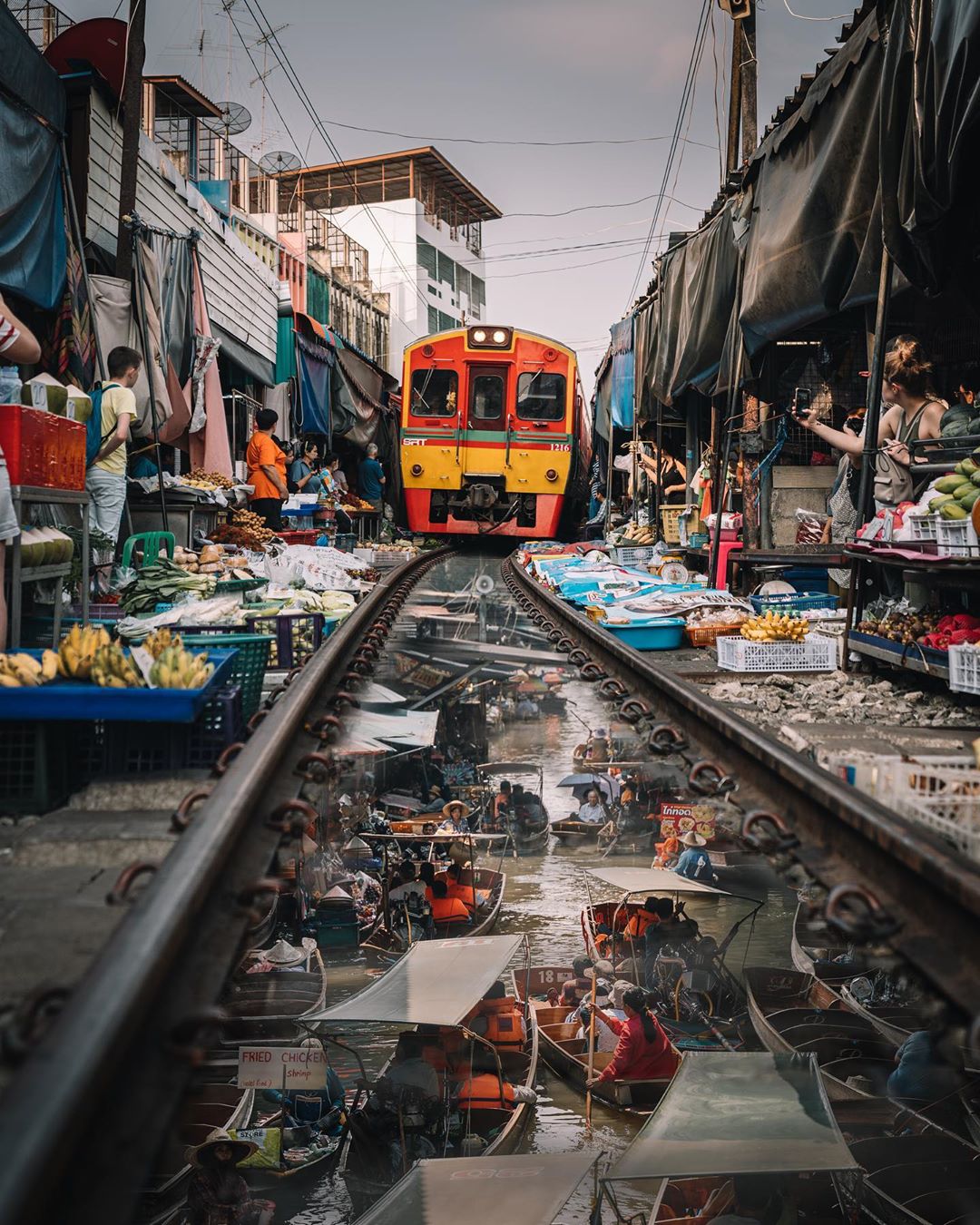 urban photography maeklong railway market by tristan zhou