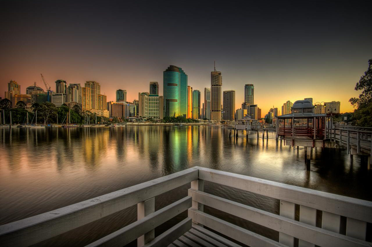 sun rising near the buildings wallpaper